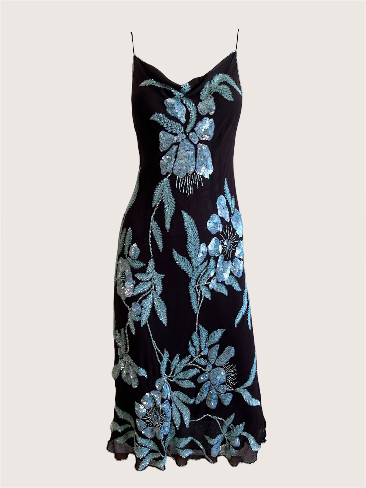 Black dress with blue floral embroidery on a light gray background