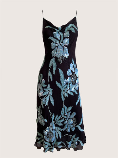 Black dress with blue floral embroidery on a light gray background